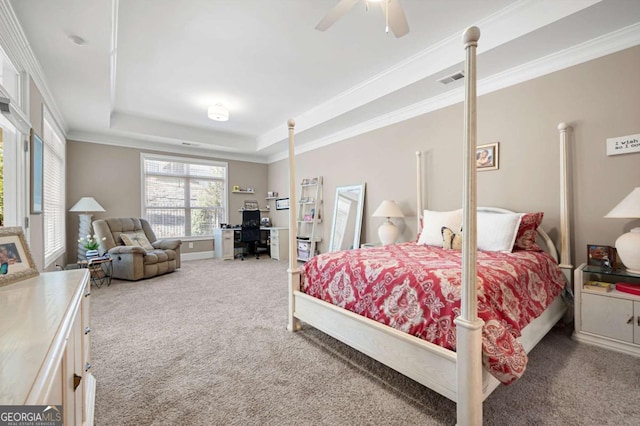 carpeted bedroom featuring ceiling fan, crown molding, and a tray ceiling