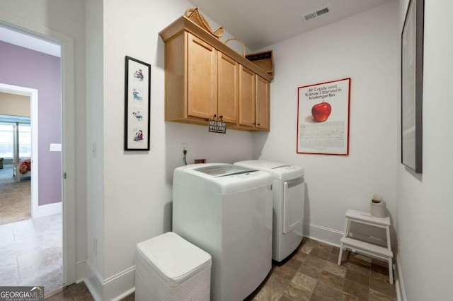 washroom with cabinets and washer and clothes dryer