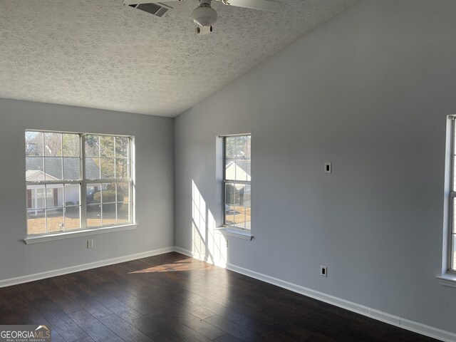 spare room featuring ceiling fan, dark wood-type flooring, a textured ceiling, and lofted ceiling