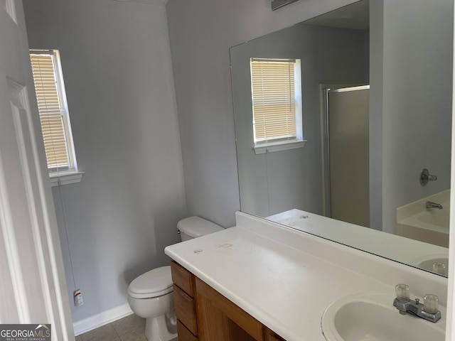 bathroom featuring a shower with shower door, tile patterned floors, vanity, and toilet