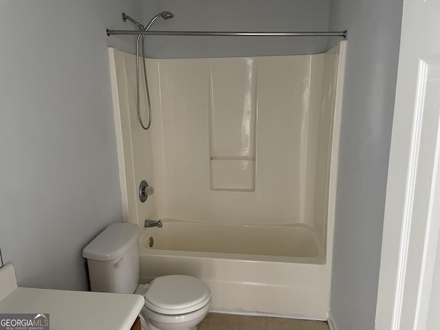 full bath with tile patterned flooring, tub / shower combination, vanity, and toilet