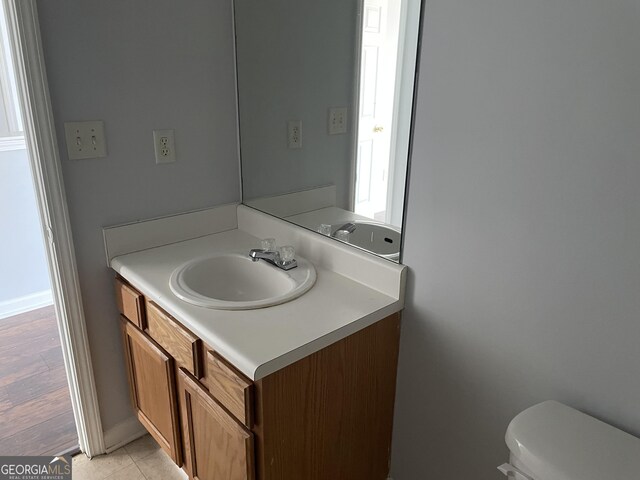 bathroom featuring tile patterned floors, vanity, and toilet