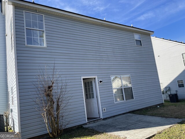 back of house with central AC unit and a patio area