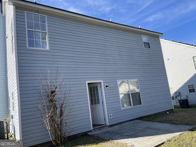 rear view of property featuring a patio area and cooling unit