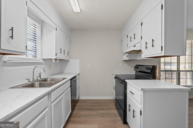 kitchen with black range with electric cooktop, dishwasher, white cabinets, and sink