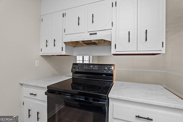 kitchen with black range with electric cooktop and white cabinets