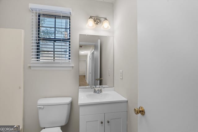 bathroom featuring toilet and vanity