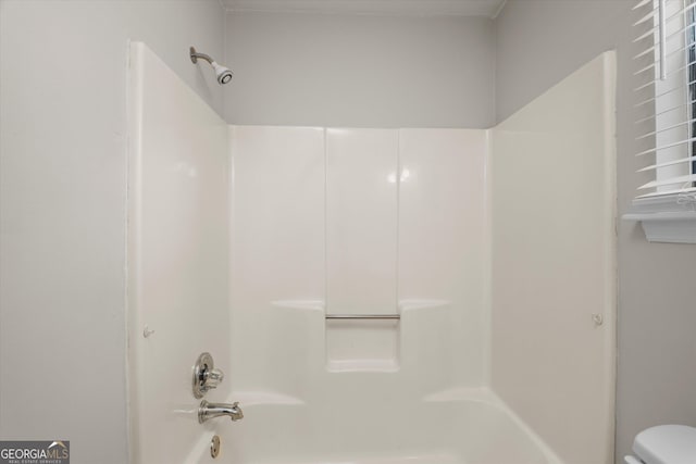 bathroom with toilet and shower / washtub combination