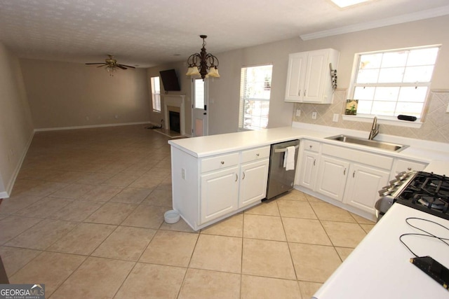 kitchen with decorative light fixtures, kitchen peninsula, sink, appliances with stainless steel finishes, and white cabinets