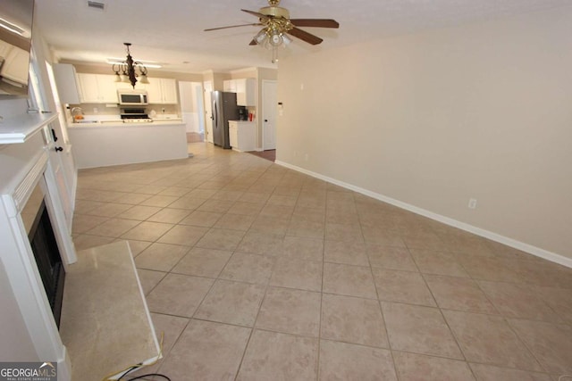 unfurnished living room featuring light tile patterned floors and ceiling fan with notable chandelier