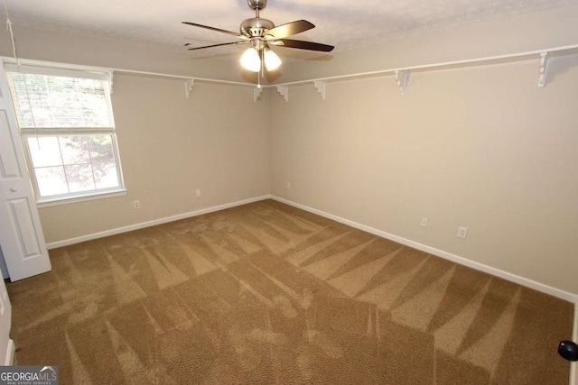 unfurnished room featuring carpet floors and ceiling fan