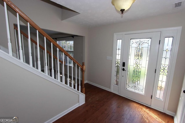 foyer with dark hardwood / wood-style floors