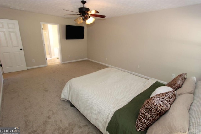 bedroom featuring ceiling fan, a textured ceiling, and light carpet