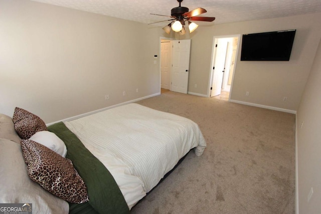 carpeted bedroom with a textured ceiling and ceiling fan