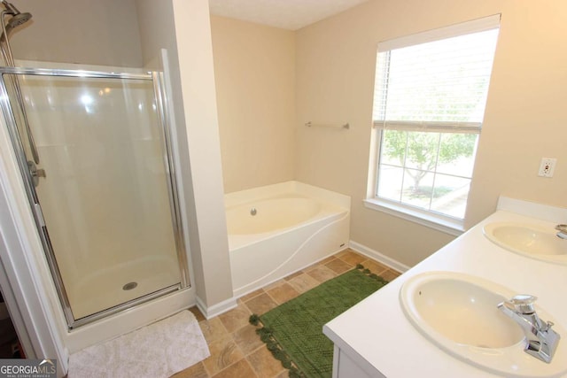 bathroom featuring independent shower and bath and vanity