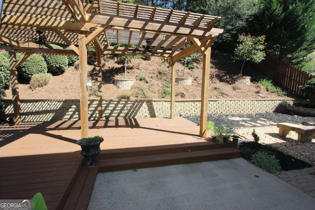 wooden terrace with ceiling fan and a pergola