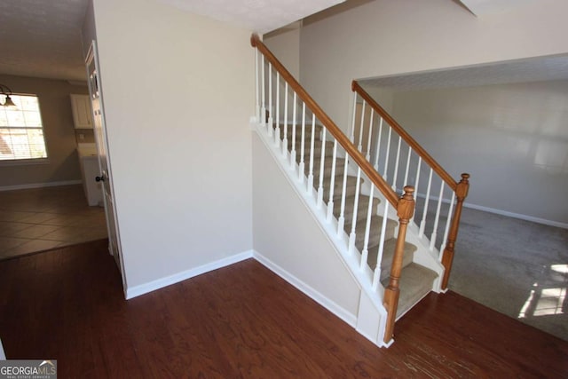 stairs featuring hardwood / wood-style floors