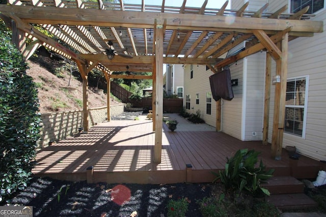 wooden terrace featuring ceiling fan and a pergola