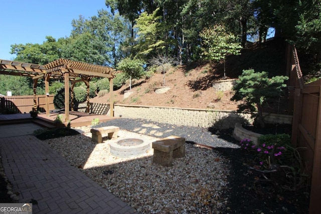 view of yard with an outdoor fire pit and a pergola