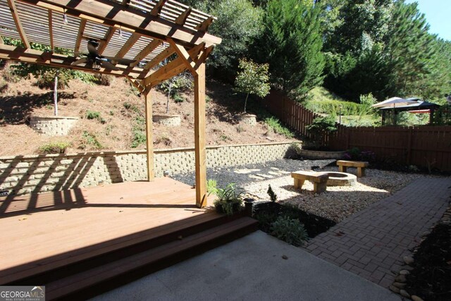 view of patio with a pergola and a deck