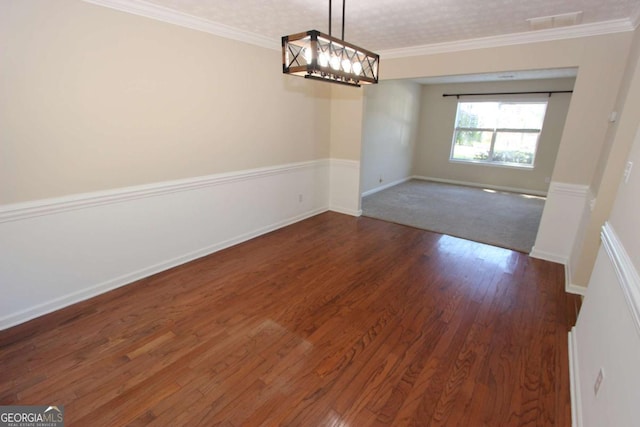 unfurnished dining area featuring a textured ceiling, dark hardwood / wood-style flooring, and ornamental molding