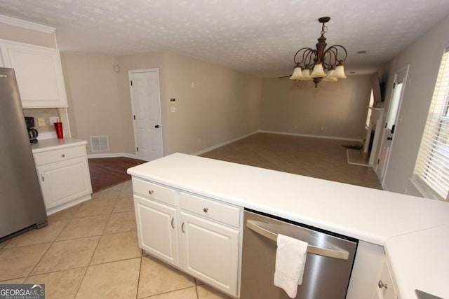 kitchen featuring white cabinetry, an inviting chandelier, stainless steel appliances, and pendant lighting