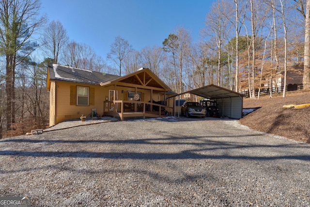 view of front of property featuring a carport and a porch