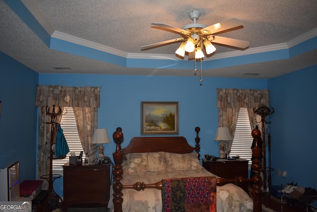 bedroom featuring visible vents, crown molding, and a textured ceiling