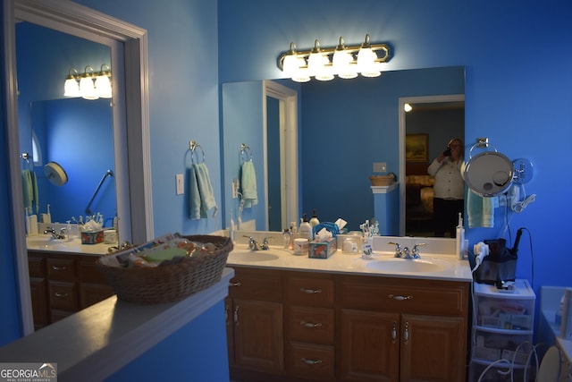 bathroom with a sink and double vanity