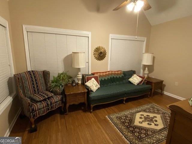 sitting room with lofted ceiling, ceiling fan, baseboards, and wood finished floors