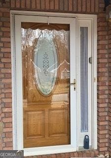 property entrance with brick siding