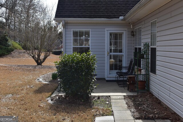 exterior space with roof with shingles