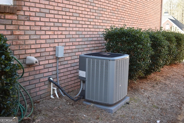 exterior details with brick siding and central air condition unit