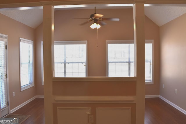 entrance foyer featuring vaulted ceiling, ceiling fan, and dark wood-type flooring