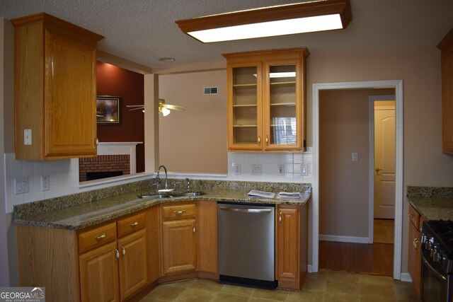 kitchen with black gas range, a sink, visible vents, dishwasher, and glass insert cabinets