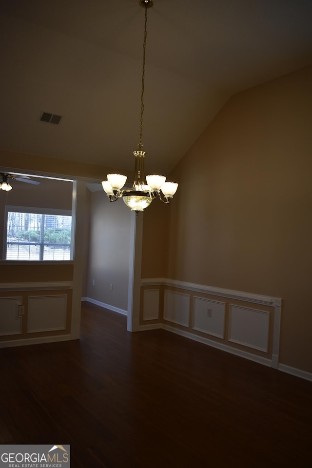 unfurnished room with baseboards, visible vents, dark wood-style floors, vaulted ceiling, and ceiling fan with notable chandelier