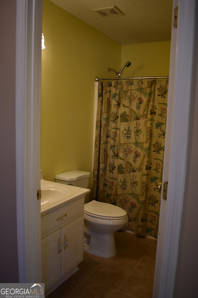 full bath with visible vents, toilet, tile patterned flooring, a textured ceiling, and vanity