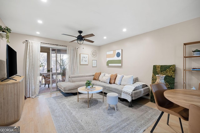 living room with ceiling fan and light wood-type flooring