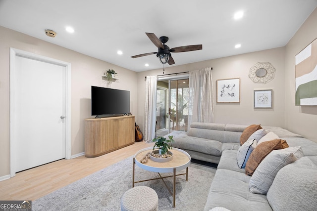 living room with ceiling fan and light hardwood / wood-style floors