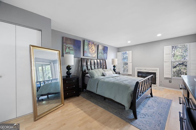 bedroom with a closet and light hardwood / wood-style flooring