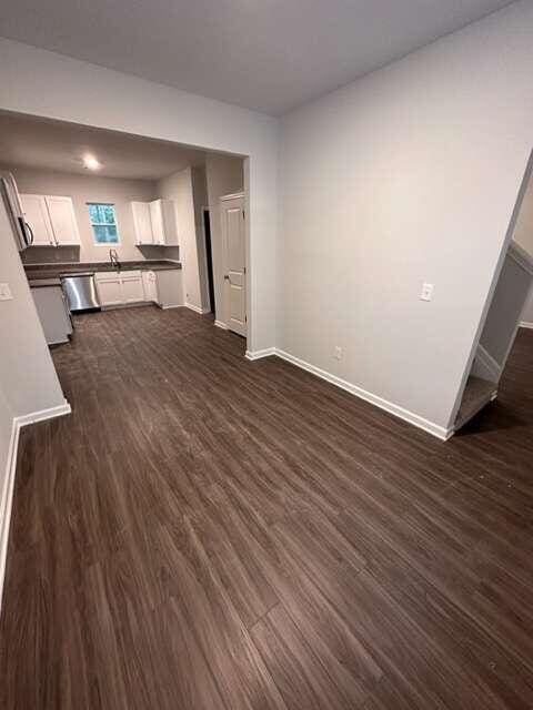 unfurnished living room with dark hardwood / wood-style floors