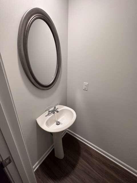 bathroom with hardwood / wood-style floors