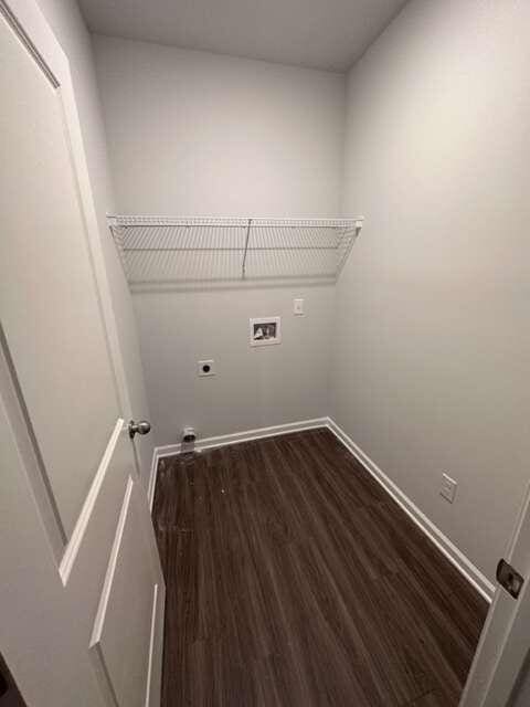 laundry area with dark wood-type flooring, washer hookup, and electric dryer hookup