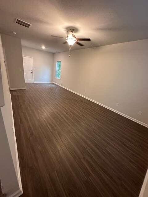 spare room with ceiling fan and dark hardwood / wood-style floors