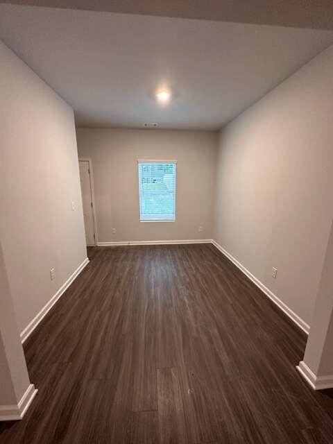 empty room with dark wood-type flooring