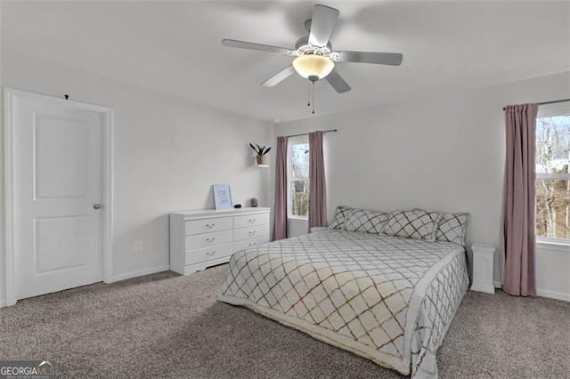 bedroom featuring ceiling fan, carpet floors, and multiple windows