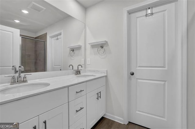 bathroom with vanity, wood-type flooring, and walk in shower