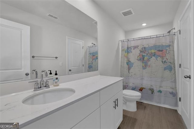 full bathroom featuring toilet, shower / bath combo, wood-type flooring, and vanity