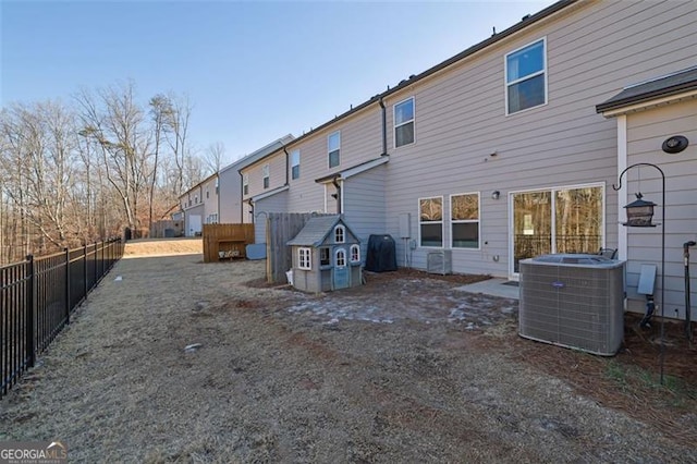 rear view of house with central AC unit