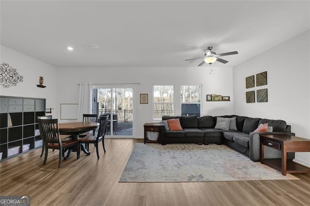 living room featuring ceiling fan and wood-type flooring